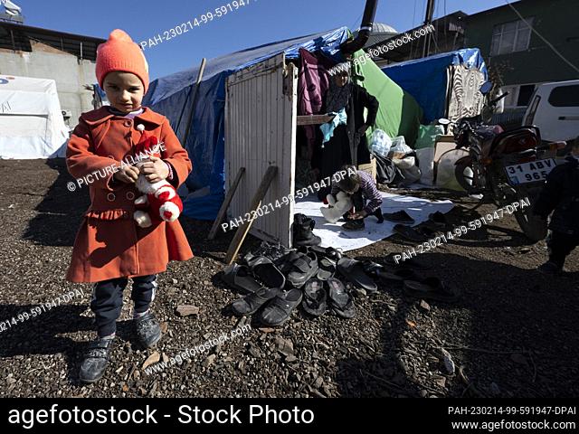 14 February 2023, Turkey, Kirikhan: Haya stands in front of a tent where she and her family have found makeshift shelter