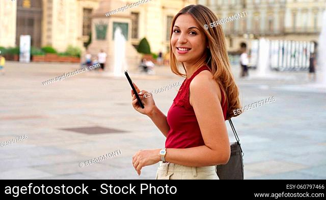 Panoramic banner of beautiful young woman using mobile phone for e-commerce outdoors. Copy space