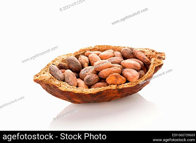 Unpeeled cocoa beans in a pod on white background