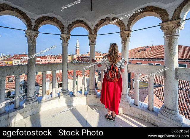 Young woman, tourist looking over Venice, dome of Palazzo Contarini del Bovolo, palace with spiral staircase, Venice, Veneto, Italy, Europe