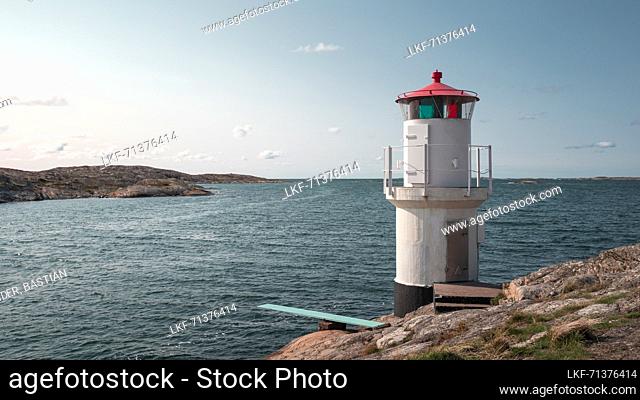 Lighthouse and bathing platform on the rocky coast of MollÃ¶sund on the archipelago island of Orust on the west coast of Sweden