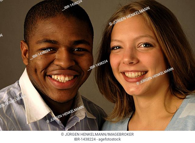 Young mixed race couple, black and white skin color, African and European, teenagers, laughing