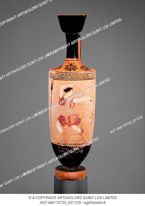 Terracotta lekythos (oil flask), Classical, ca. 440 B.C., Greek, Attic, Terracotta; white-ground, H. 12 7/8 in. (32.7 cm), Vases, Amazon using a slingshot