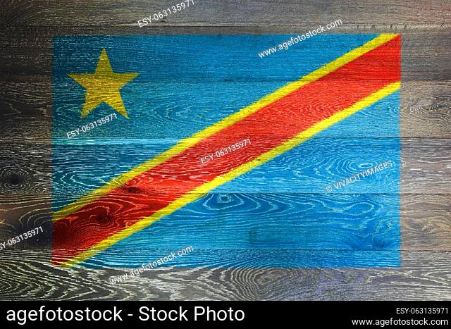 A Democratic Republic of Congo flag on rustic old wood surface background