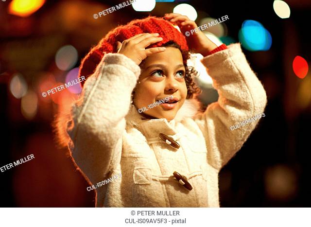 Young girl, outdoors at night, wearing coat and red beret