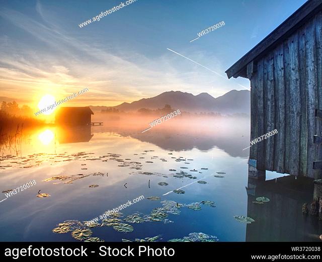 Romantic mountain lake view. The mountain lake with dock and boat house