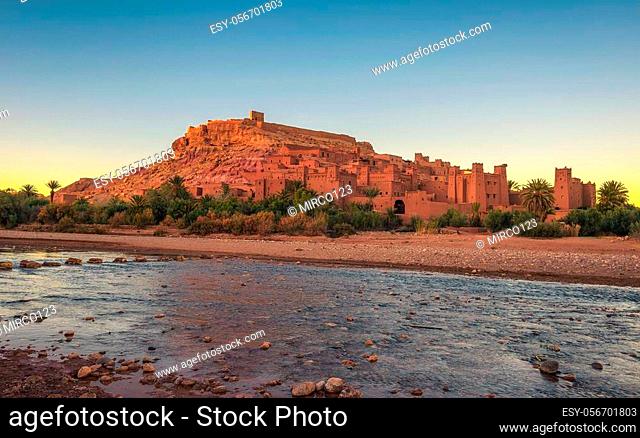 Ait Benhaddou with Asif Ounila river in Morocco at sunset. This city was built along the caravan route between Sahara and Marrakech and is a popular filming...