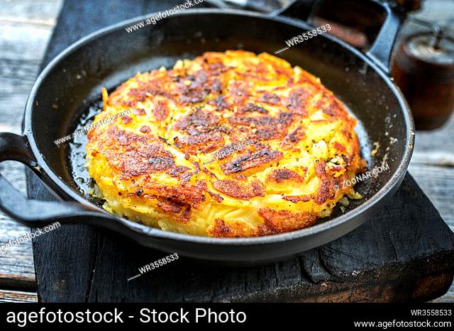 Traditional Swiss hash browns as side dish as closeup in a frying pan