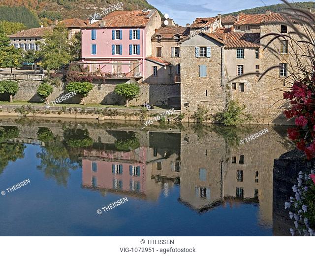 river Aveyron with different houses colour pink with reflection at river, Saint-Antonin-Noble-Val, Midi-Pyrenees, Tarn-et-Garonne, France