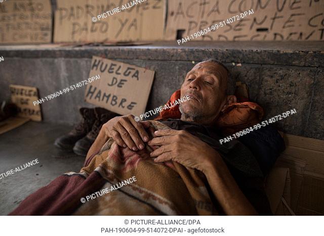 04 June 2019, Venezuela, Caracas: A man is lying in a camp where former oil workers are attracting attention with a hunger strike