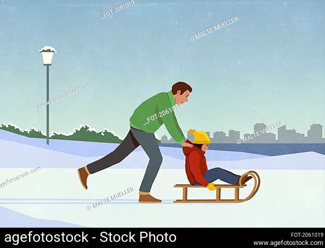 Father pushing daughter on sled in snowy winter city park