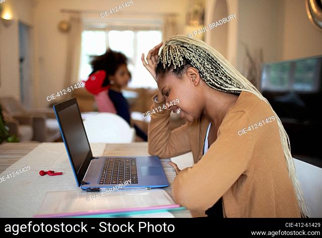 Frustrated woman working from home at laptop