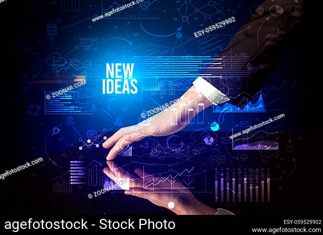 Businessman touching huge screen with NEW IDEAS inscription, cyber business concept