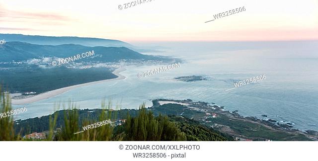 river mouth of Rio Minho between northern Portugal and Galicia in Spain in the evening sun with view onto the city of Moledo do Minho