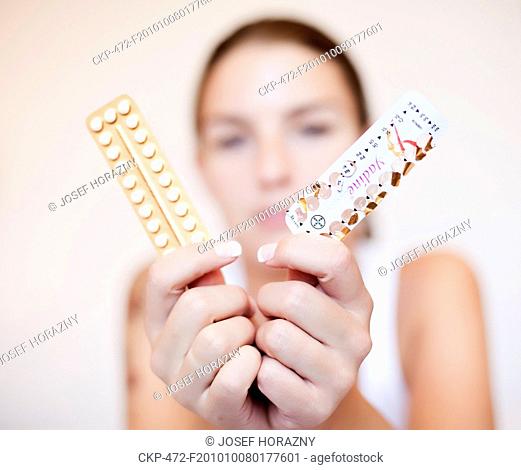 Young woman with contraceptive pills, birth-control pill, blister pack of combined oral contraceptive pills, birth control