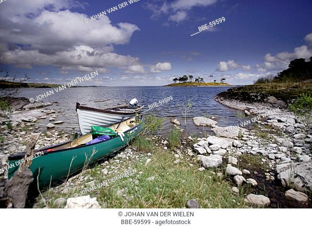 boats at an island in the lake Lough Mask, Ireland