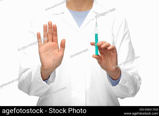 close up of doctor with syringe shows stop gesture