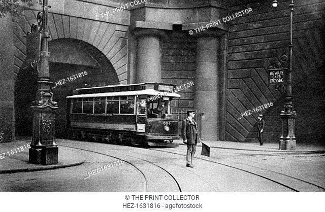 A tram running beneath Kingsway, Aldwych and Somerset House, London, 1926-1927. From Wonderful London, volume II, edited by Arthur St John Adcock