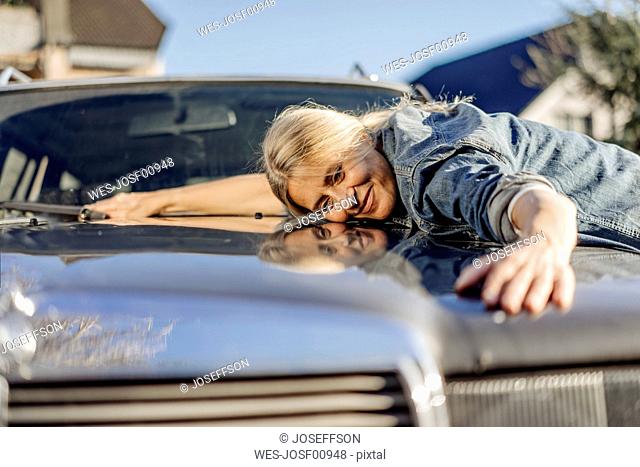 Woman lying on her car