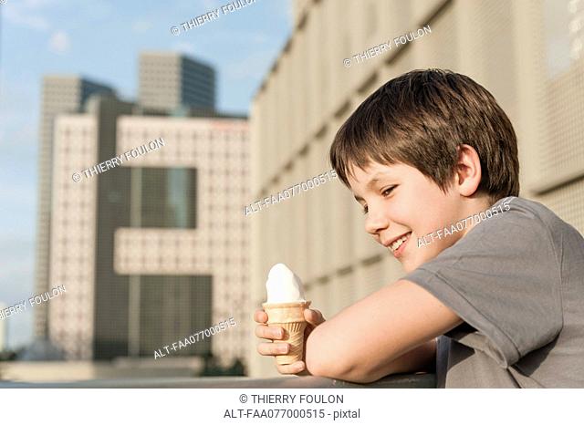 Boy holding ice cream cone, portrait