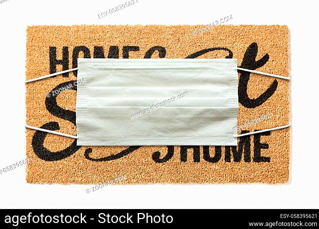 Welcome Mat With Medical Face Mask Amidst The Coronavirus Pandemic Isolated on White