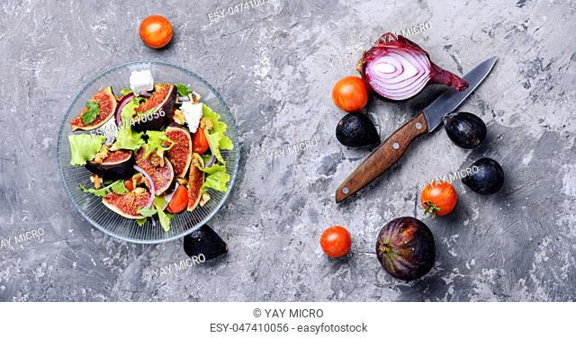 Autumn salad with arugula, olive, figs and cheese.Vegetarian salad.European food