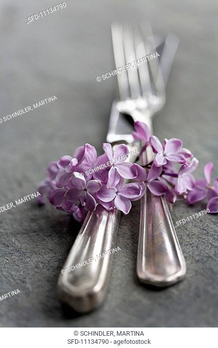 Silver cutlery with lilac flowers