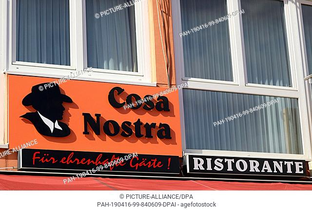 18 March 2019, North Rhine-Westphalia, Köln: A sign with the name of the Italian restaurant ""Cosa Nostra"" with the addition ""For honourable guests"" hangs...