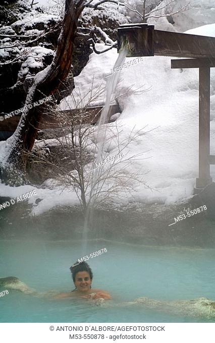 A woman have a bath in an open air hotspring. Awanoyu onsen. Shiraone-onsen azumi. Matsumoto. Nagano prefecture. Chubu Region. Japan