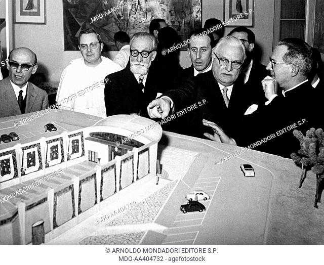Aldo Fascetti pointing at the scale model of a building. Italian president of the Institute for Industrial Reconstruction (IRI) Aldo Fascetti pointing at the...