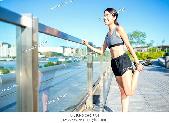 Woman stretching legs before run