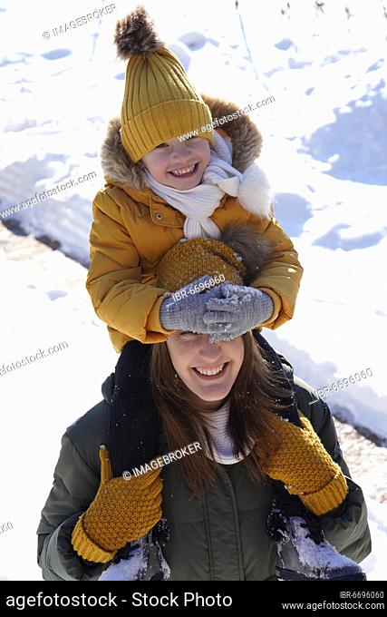 Mother and daughter, 6 years old, in winter in the snow, Karlovy Vary, Czech Republic, Europe