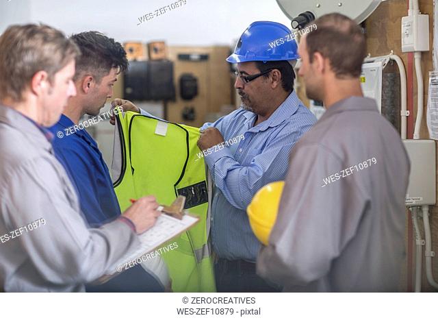 Instructor in a workshop showing safety vest
