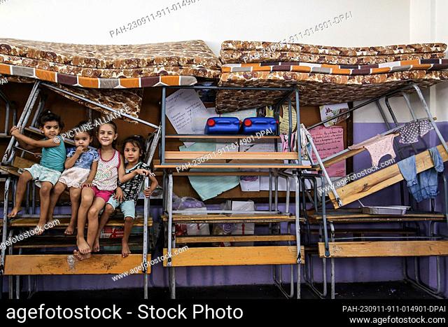 11 September 2023, Lebanon, Sidon: Palestinian refugee children sit amid school tables and chairs at a United Nations Relief and Works Agency (UNRWA) school in...