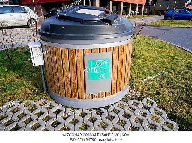 Modern locked green ecological trash bin in the new residential city area