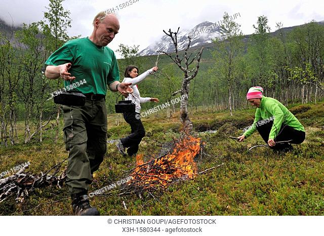 man making a campfire, Nordmannvikdalen valley, region of Lyngen, County of Troms, Norway, Northern Europe