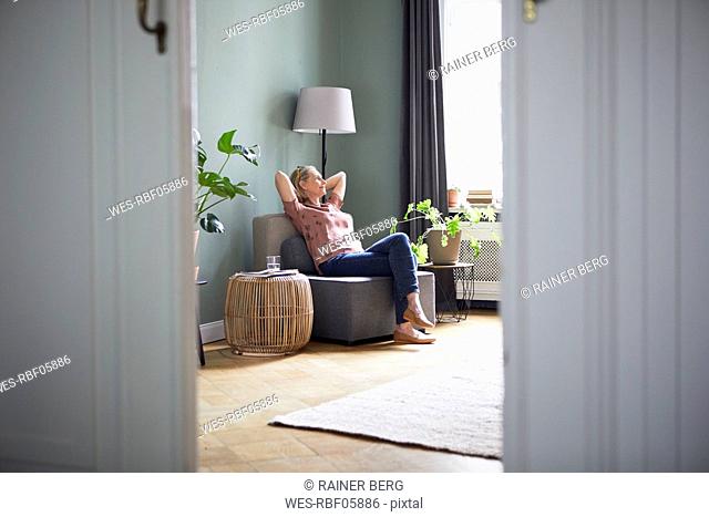 Relaxed mature woman sitting at home