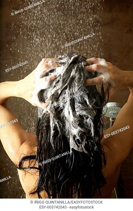 woman washing her hair under shower water