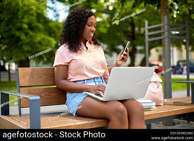 african student girl with laptop and smartphone