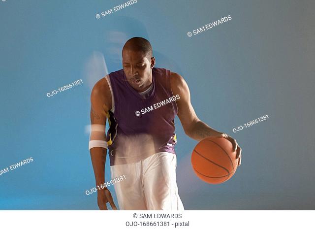 Blurred view of basketball player dribbling