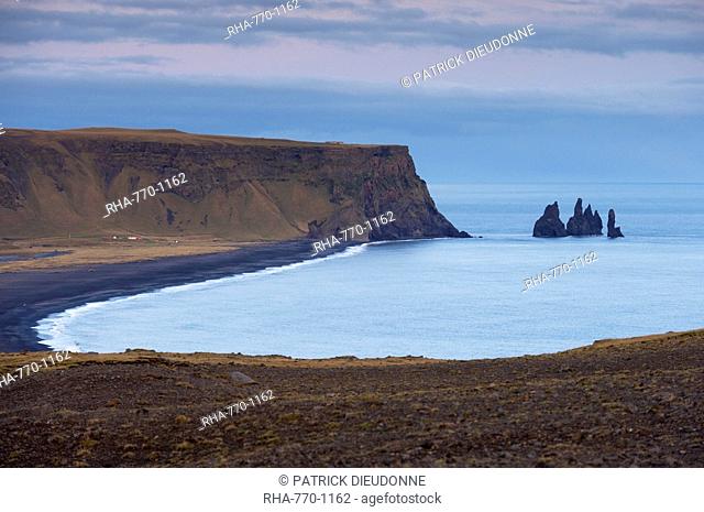 Black sand beach, rock formation and Reynisdrangar sea stacks in the distance, from Dyrholaey near Vik, Iceland, Polar Regions