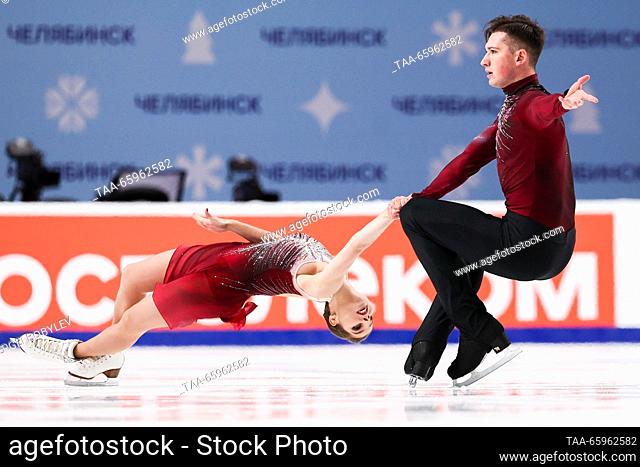 RUSSIA, CHELYABINSK - DECEMBER 21, 2023: Pair skaters Anastasia Mishina and Alexander Gallyamov perform a death spiral during a pairs' short programme event as...