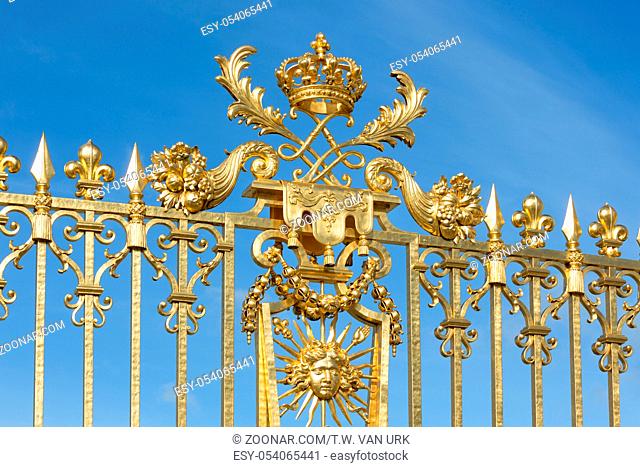 Golden gate with ornament of the Palace Versailles near Paris, France