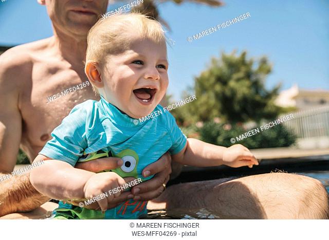Baby enjoying the swimming pool during summer vacation