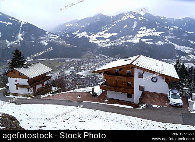 Zell am Ziller, Austria, March 11, 2019: Small apartment hotels built in Tyrolean style on the mountainside above the ski resort of Zell am Ziller