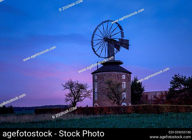 Spooky landscape with haunted wind mill at night. Moment after sunset. Windmill called Ruprechtov in Czech republic. Close to Moravsky Kras