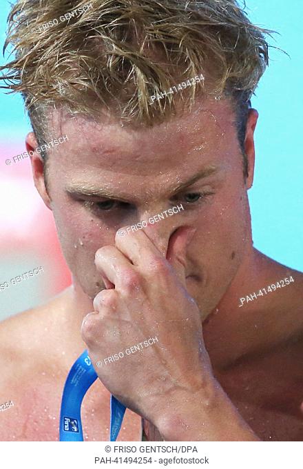 Steffen Deibler of Germany looks dejected after the men's 100m butterfly final of the 15th FINA Swimming World Championships at Palau Sant Jordi Arena in...