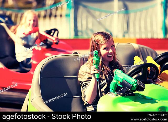 Happy teen girls driving a bumper cars