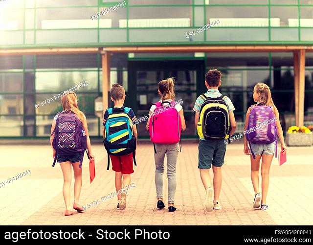 group of happy elementary school students walking