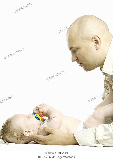 Man playing with an infant